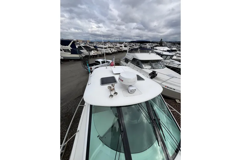 Slide: The Image of 2010 Boston Whaler 345 Conquest boat deck under cloudy sky. - 10