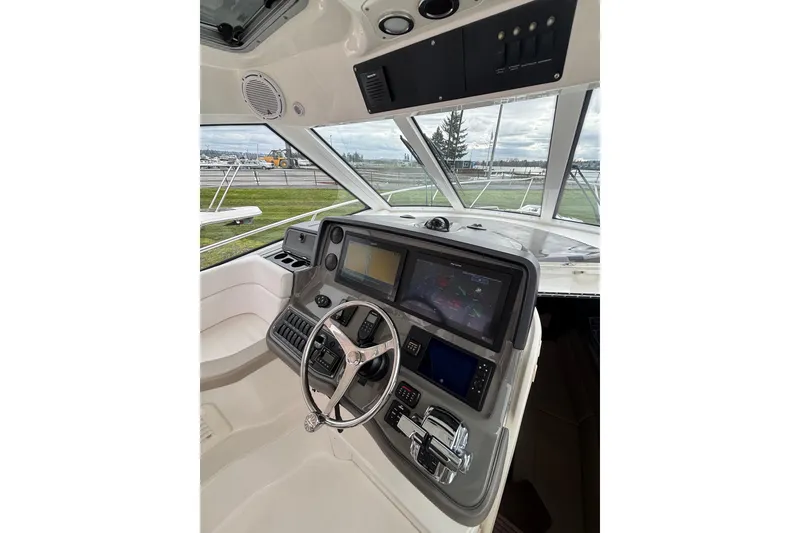 Slide: The Image of 2010 Boston Whaler 345 Conquest boat on dry dock, viewed from the front. - 13