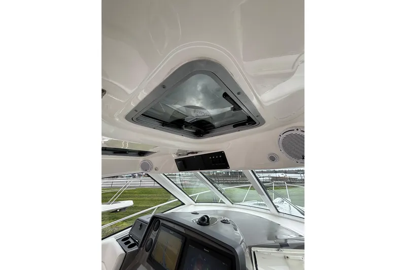 Slide: The Image of 2010 Boston Whaler 345 Conquest docked among other boats under cloudy skies. - 15