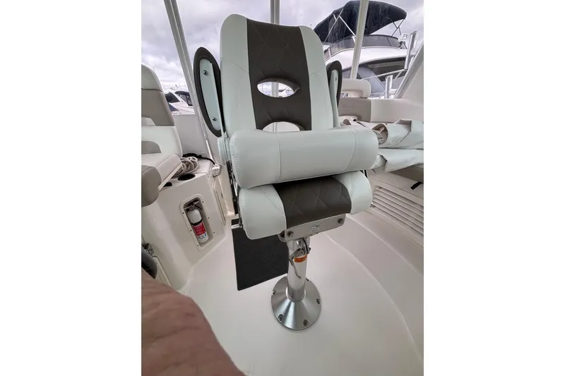 Slide: The Image of Helm of 2010 Boston Whaler 345 Conquest with modern navigation equipment and steering wheel. - 17
