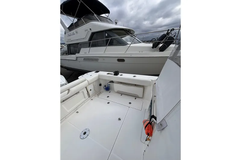 Slide: The Image of Captain's chair on 2010 Boston Whaler 345 Conquest boat, with marina view. - 21