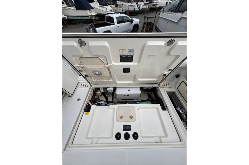 Slide: The Image of 2010 Boston Whaler 345 Conquest boat on dry dock under cloudy sky. - 24