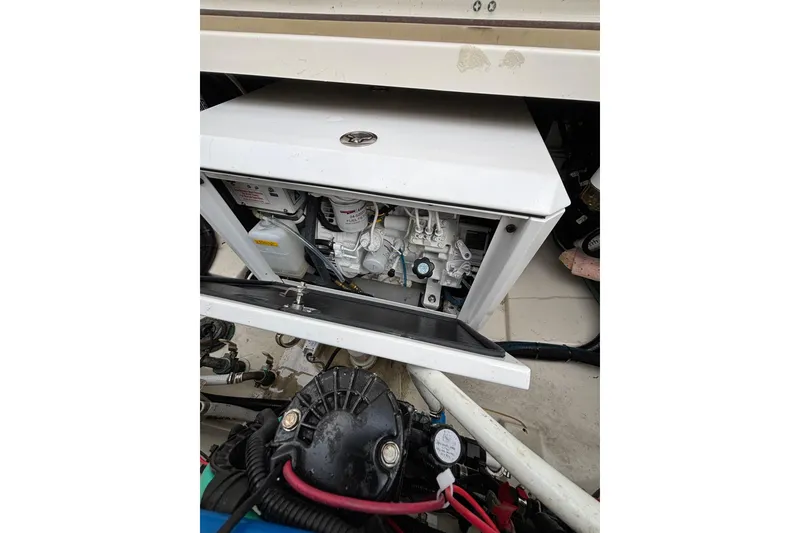 Slide: The Image of 2010 Boston Whaler 345 Conquest boat docked beside another vessel under cloudy skies. - 26