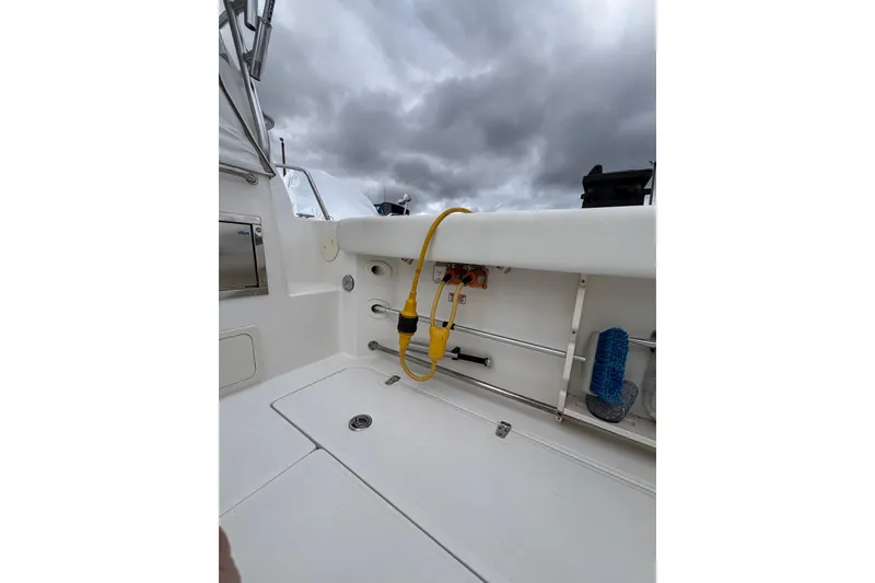 Slide: The Image of 2010 Boston Whaler 345 Conquest deck with storage compartments and seating. - 28