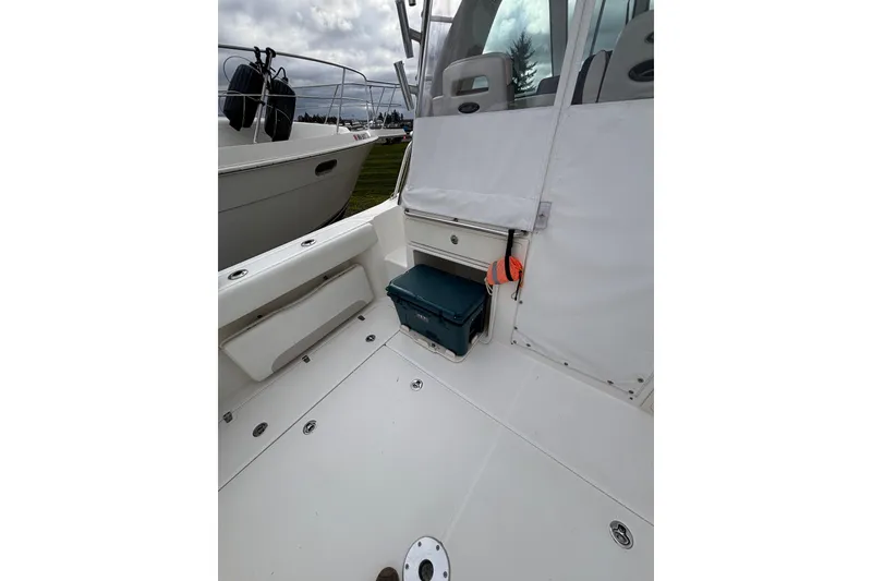 Slide: The Image of Engine compartment of a 2010 Boston Whaler 345 Conquest boat, showcasing internal components. - 29