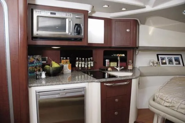 Slide: The Image of 2010 Boston Whaler 345 Conquest boat docked under cloudy skies. - 3