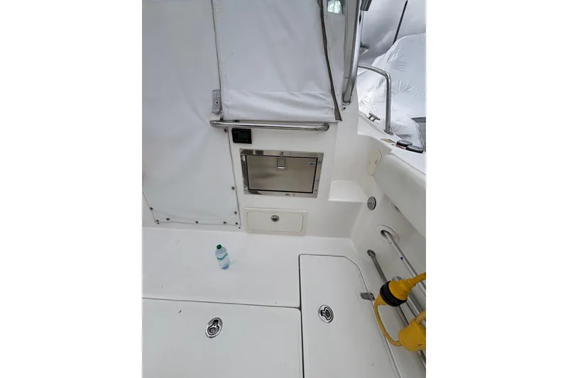 Slide: The Image of Engine compartment of a 2010 Boston Whaler 345 Conquest boat, showcasing internal components. - 30