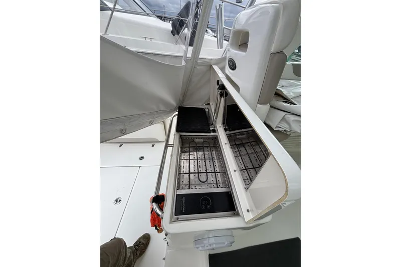 Slide: The Image of Inspecting engine components of a 2010 Boston Whaler 345 Conquest boat. - 32