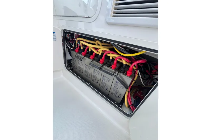 Slide: The Image of 2010 Boston Whaler 345 Conquest deck with hose and cleaning tools under cloudy sky. - 33