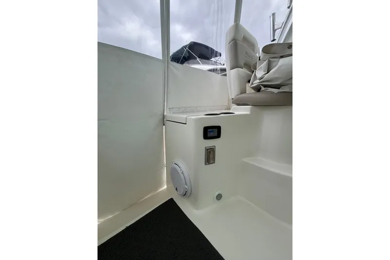 Slide: The Image of 2010 Boston Whaler 345 Conquest boat deck with storage compartment and seating. - 34