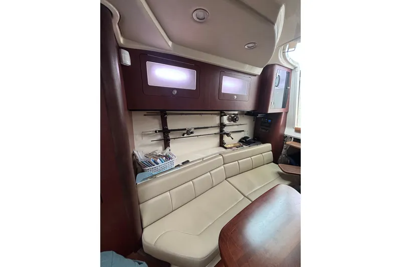 Slide: The Image of 2010 Boston Whaler 345 Conquest interior with open storage compartment and seating area. - 37