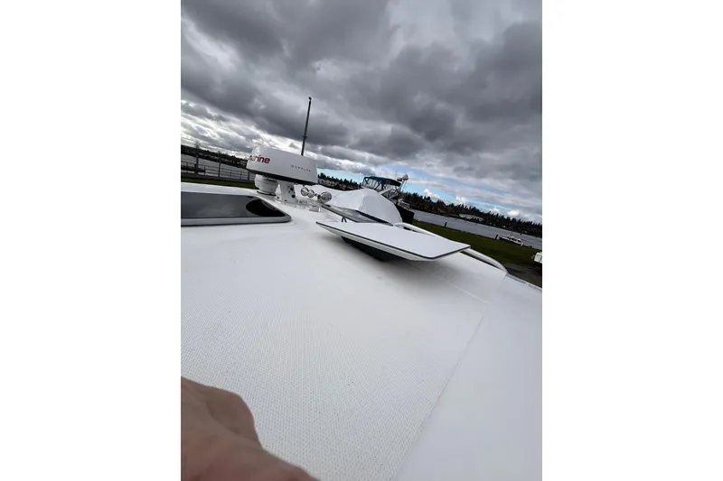 Slide: The Image of 2010 Boston Whaler 345 Conquest boat on dry dock under cloudy skies. - 5