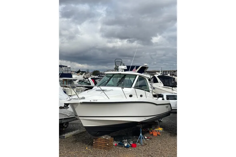 Slide: The Image of Interior view of 2010 Boston Whaler 345 Conquest boat with seating and control panel. - 51