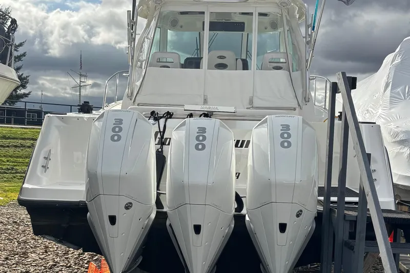 Slide: The Image of 2010 Boston Whaler 345 Conquest with triple 300 horsepower engines, docked outdoors. - 58