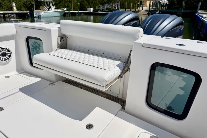 Slide: The Image of 2021 Sportsman Open 302 Center Console with foldable seat and twin engines at dock. - 11