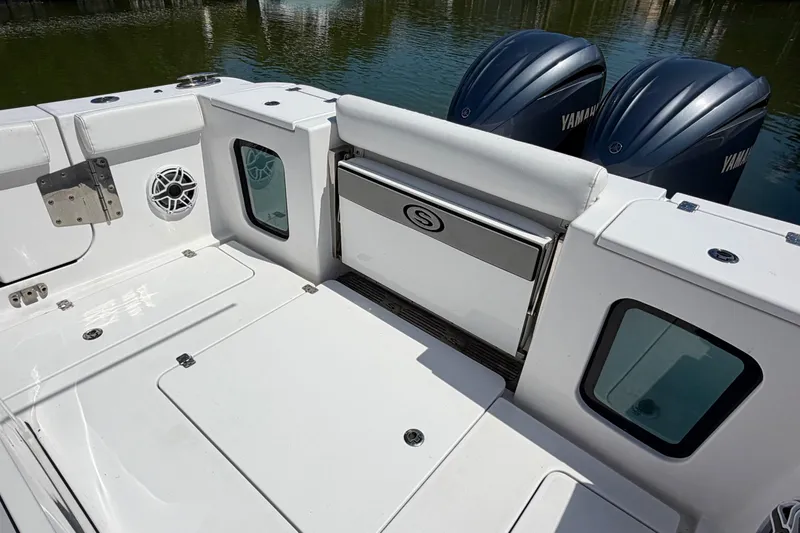 Slide: The Image of 2021 Sportsman Open 302 Center Console boat with Yamaha engines, featuring spacious deck and seating. - 12