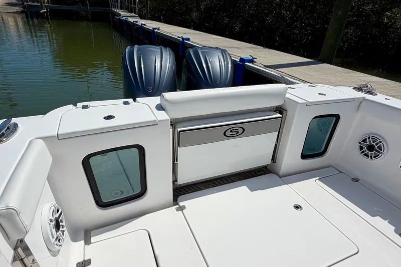 Slide: The Image of 2021 Sportsman Open 302 Center Console boat with dual engines at dock. - 13