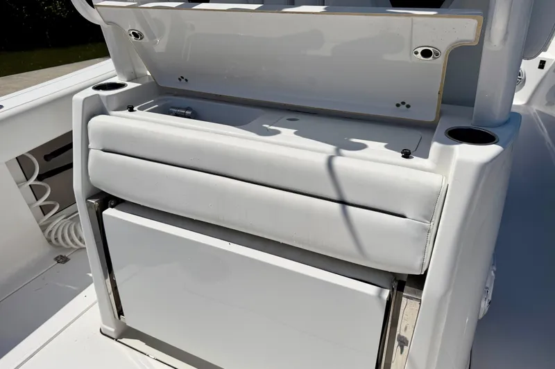 Slide: The Image of 2021 Sportsman Open 302 Center Console boat interior with seating and storage. - 14