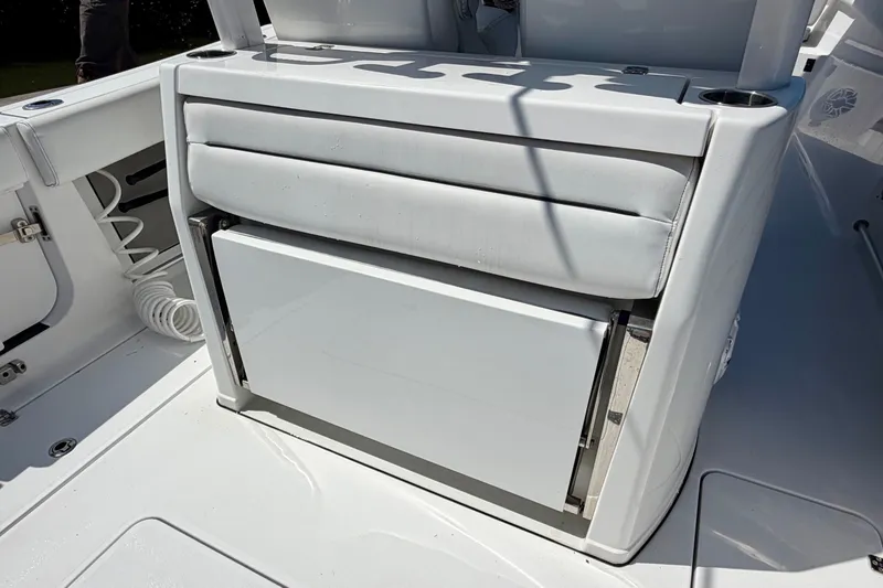 Slide: The Image of 2021 Sportsman Open 302 Center Console boat interior with seating and storage. - 15