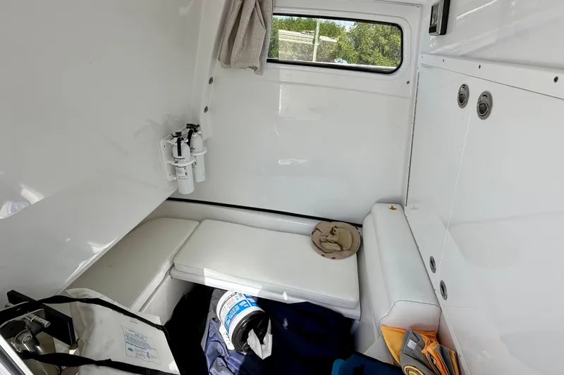 Slide: The Image of 2021 Sportsman Open 302 Center Console cabin interior with seating and storage. - 18