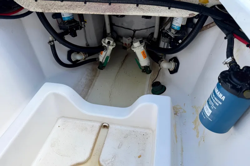 Slide: The Image of 2021 Sportsman Open 302 Center Console bilge area with pumps and filters visible. - 21