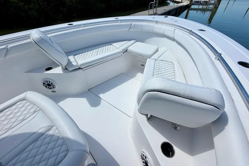 Slide: The Image of 2021 Sportsman Open 302 Center Console boat interior with cushioned seating and speaker. - 5