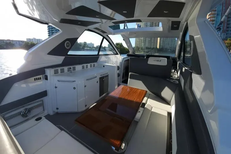 Slide: The Image of Interior of 2021 Cruisers Yachts 42 GLS OB, featuring sleek seating and modern design. - 13