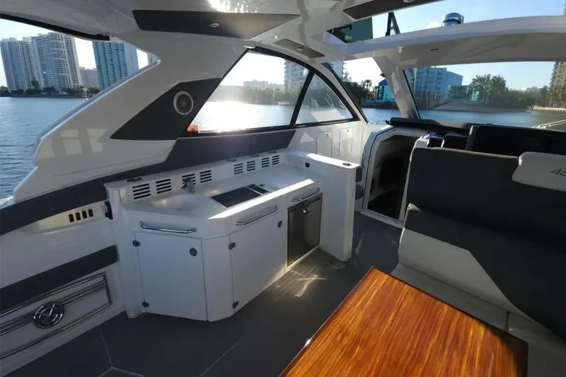 Slide: The Image of Interior of 2021 Cruisers Yachts 42 GLS OB with modern design and waterfront view. - 15