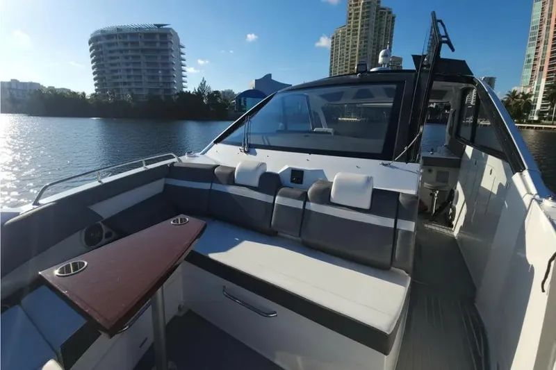 Slide: The Image of 2021 Cruisers Yachts 42 GLS OB on water, featuring spacious seating and modern design. - 24