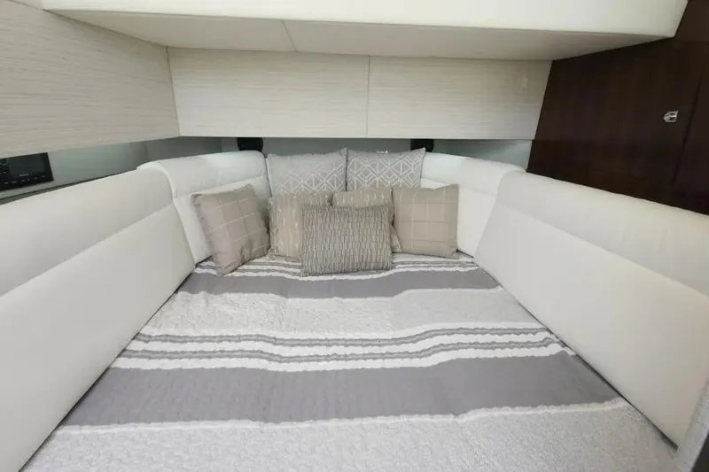 Slide: The Image of Luxurious cabin interior of 2021 Cruisers Yachts 42 GLS OB with plush bedding. - 25