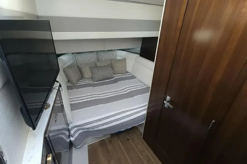 Slide: The Image of Luxurious cabin interior of 2021 Cruisers Yachts 42 GLS OB with cozy bedding and TV. - 26