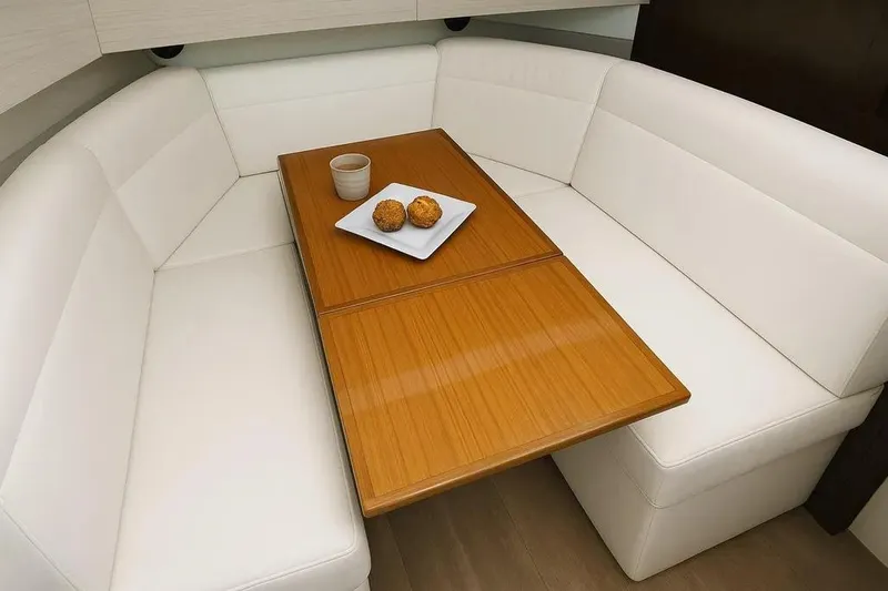 Slide: The Image of Luxurious interior of 2021 Cruisers Yachts 42 GLS OB with white seating and wooden table. - 29