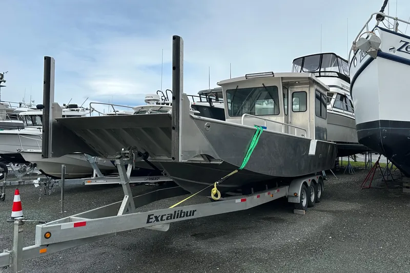 The Image of 2026 Bayview Boats 30 Landing Craft on trailer, parked among other boats. - 0