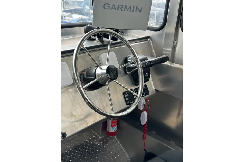 Slide: The Image of Steering wheel and controls of 2026 Bayview Boats 30 Landing Craft with Garmin navigation. - 11