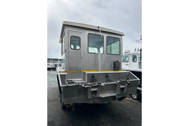 Slide: The Image of Bayview Boats 2026 model 30 Landing Craft, docked, rear view, overcast sky. - 15