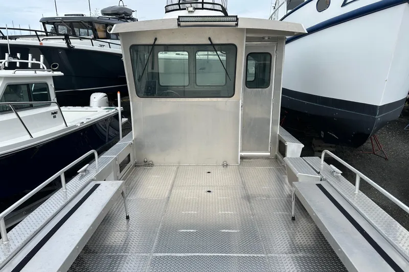 Slide: The Image of Bayview Boats 2026 model 30 Landing Craft, docked with spacious deck and cabin view. - 3