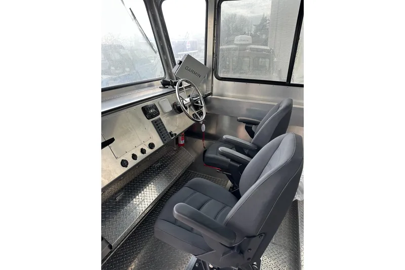 Slide: The Image of Interior of 2026 Bayview Boats 30 Landing Craft with steering wheel and navigation equipment. - 7