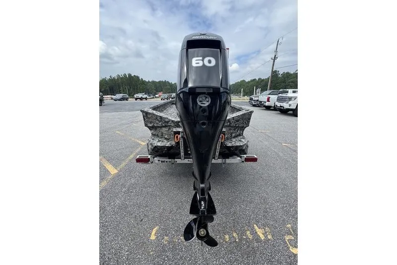 Slide: The Image of 2024 Havoc 1756 MRST boat with a 60 HP Mercury outboard motor, parked outdoors. - 10