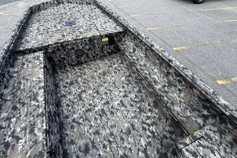 Slide: The Image of 2024 Havoc 1756 MRST boat with camouflage interior design in a parking lot. - 11