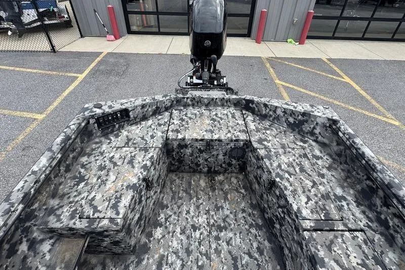 Slide: The Image of 2024 Havoc 1756 MRST boat with camo interior, parked outdoors. - 12
