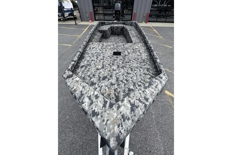 Slide: The Image of 2024 Havoc 1756 MRST boat with digital camouflage design, parked outdoors. - 14