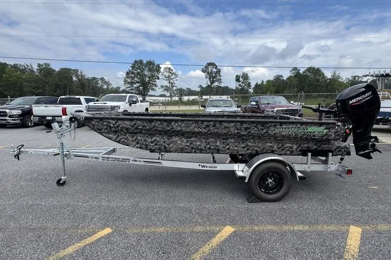 Slide: The Image of 2024 Havoc 1756 MRST boat on trailer, parked outdoors with cloudy sky. - 4