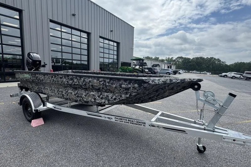 Slide: The Image of 2024 Havoc 1756 MRST boat on trailer at dealership, cloudy sky background. - 7