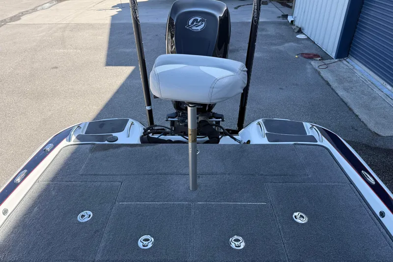 Slide: The Image of 2017 Phoenix 721 ProXP boat deck with seat and motor, parked outdoors. - 11