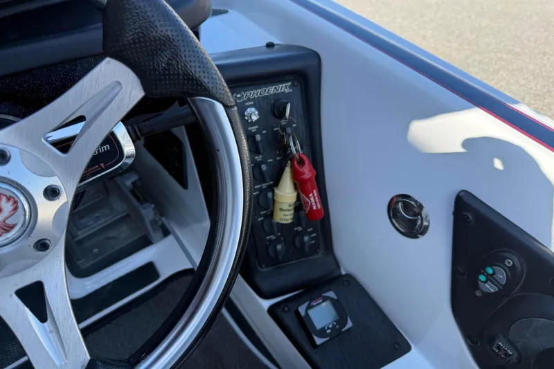 Slide: The Image of 2017 Phoenix 721 ProXP boat dashboard with steering wheel and control panel. - 13