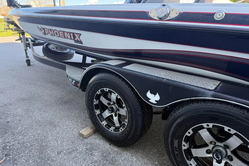 Slide: The Image of 2017 Phoenix 721 ProXP boat on trailer, showcasing sleek design and branding. - 6