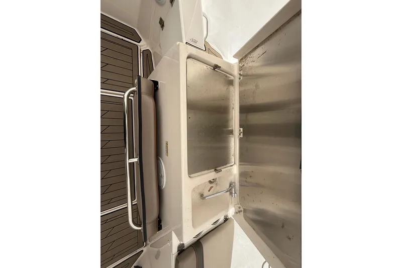 Slide: The Image of 2022 Cutwater C-24 Coupe interior with stainless steel sink and wooden flooring. - 21