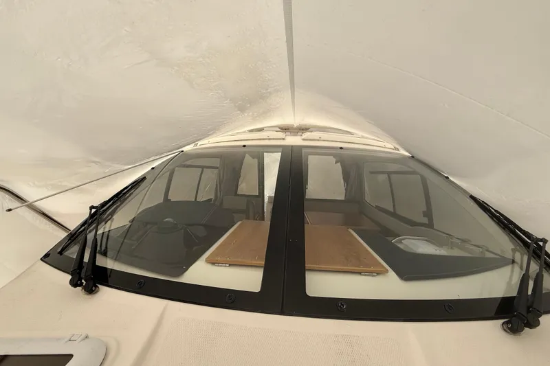Slide: The Image of 2022 Cutwater C-24 Coupe interior view through windshield, showcasing dashboard and seating area. - 22