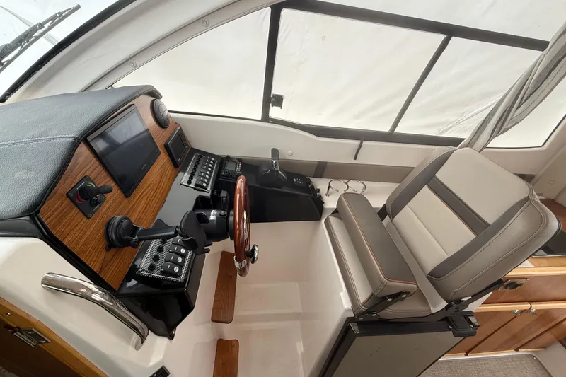 Slide: The Image of 2022 Cutwater C-24 Coupe helm with modern controls and comfortable seating. - 32