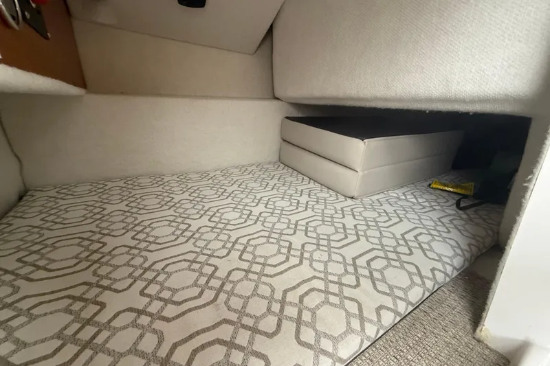 Slide: The Image of Interior cabin of 2022 Cutwater C-24 Coupe with patterned bedding and cushions. - 43